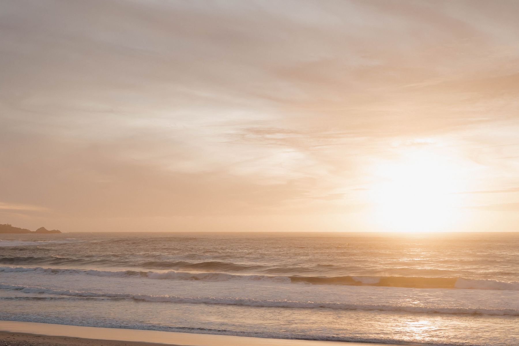 Stock photo of a California beach at sunset (illustrative; Carmel Beach, not Long Beach)