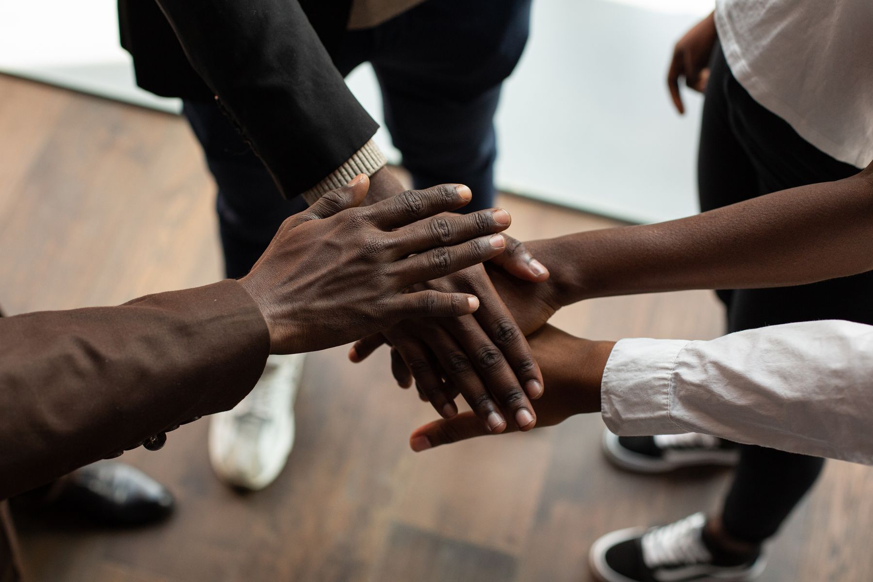 Stock photo of diverse hands stacked (illustrative)